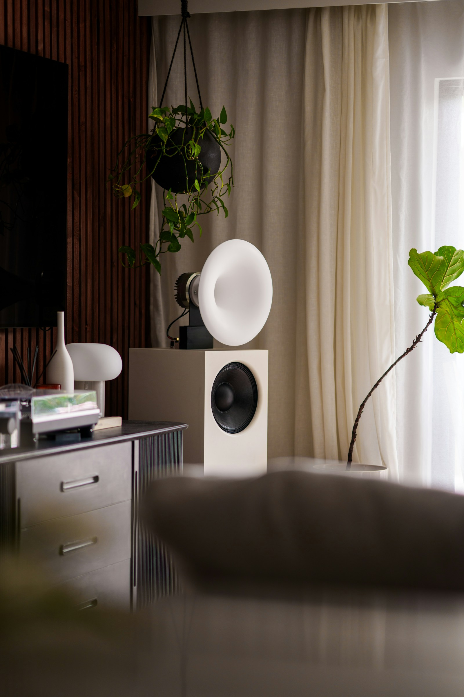 A horn loudspeaker and turntable in a styled living room